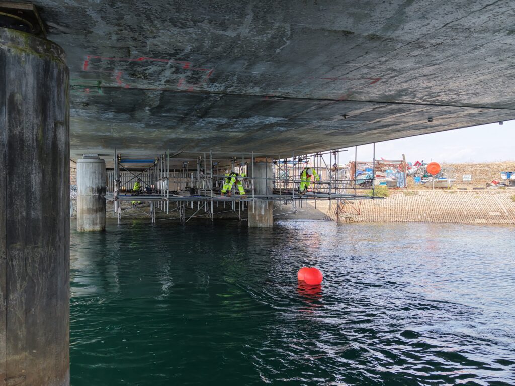Suspended scaffold and TWK operatives beneath Ferry Bridge in Weymouth