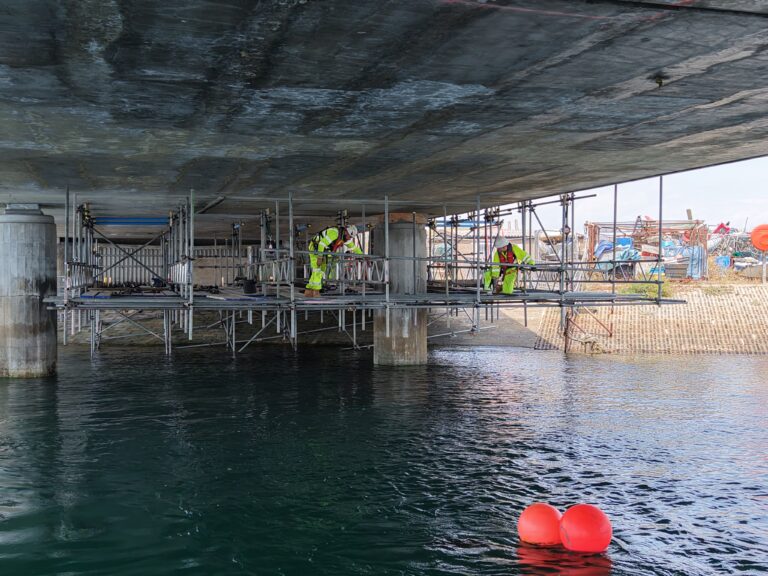 Suspended access scaffold beneath Ferry Bridge over the water in Weymouth