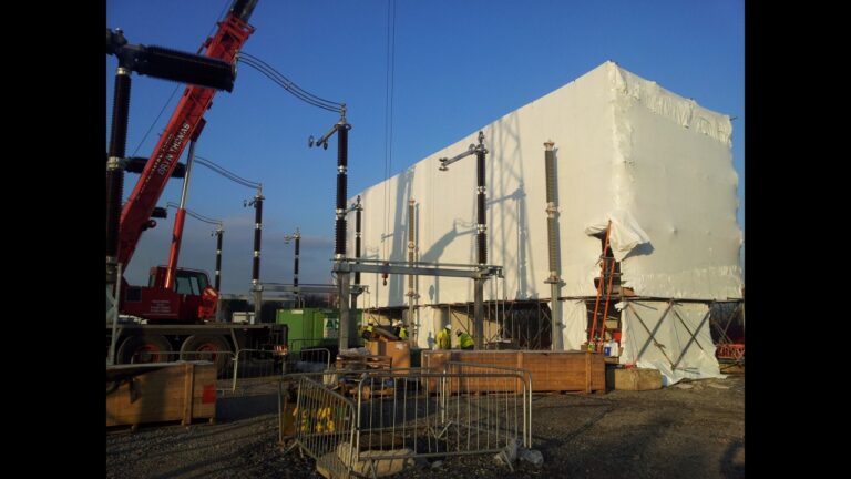 Shrink-wrapped scaffold enclosure beside electrical infrastructure