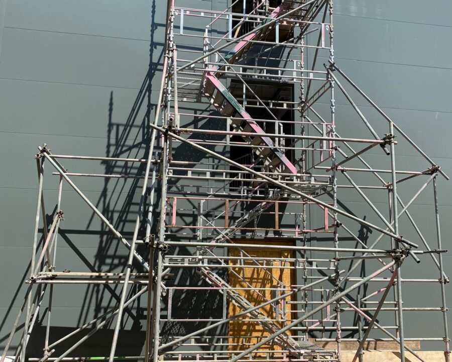 HAKI stair tower providing access to an upper-level opening in a building