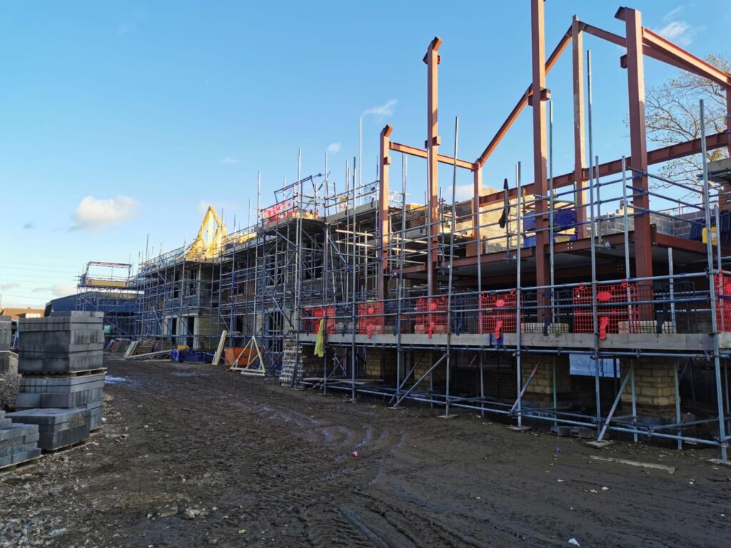 Access scaffold alongside the steel frame of the Barchester care-home development in Hamworthy, Poole