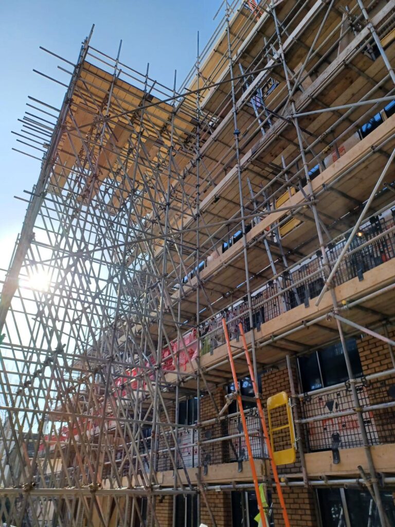 View up the boarded scaffold lifts beside Hendy House in Bournemouth