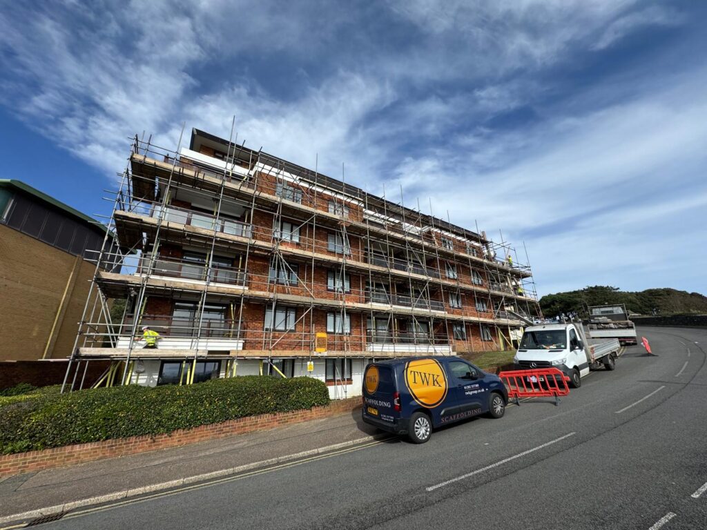 Access scaffolding around the frontage of Marina Towers in Bournemouth, with a TWK van on site