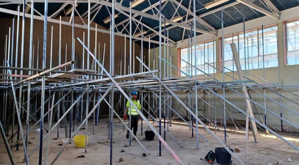 Internal birdcage scaffold beneath the roof structure at Poole Grammar School in Poole