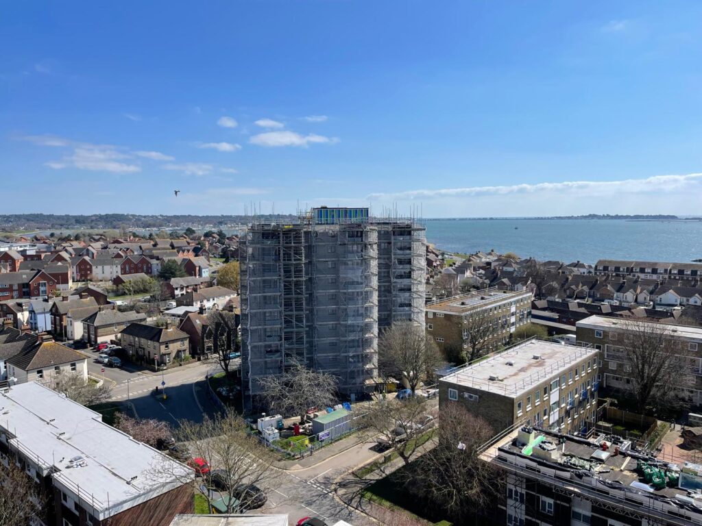 Aerial view of netted scaffold around a Project Admiral residential tower in Poole