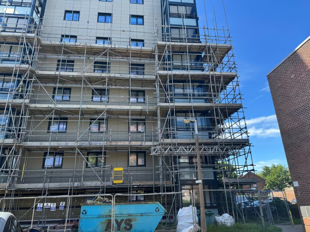 Scaffold platforms and a construction hoist beside a residential tower at Project Admiral in Poole