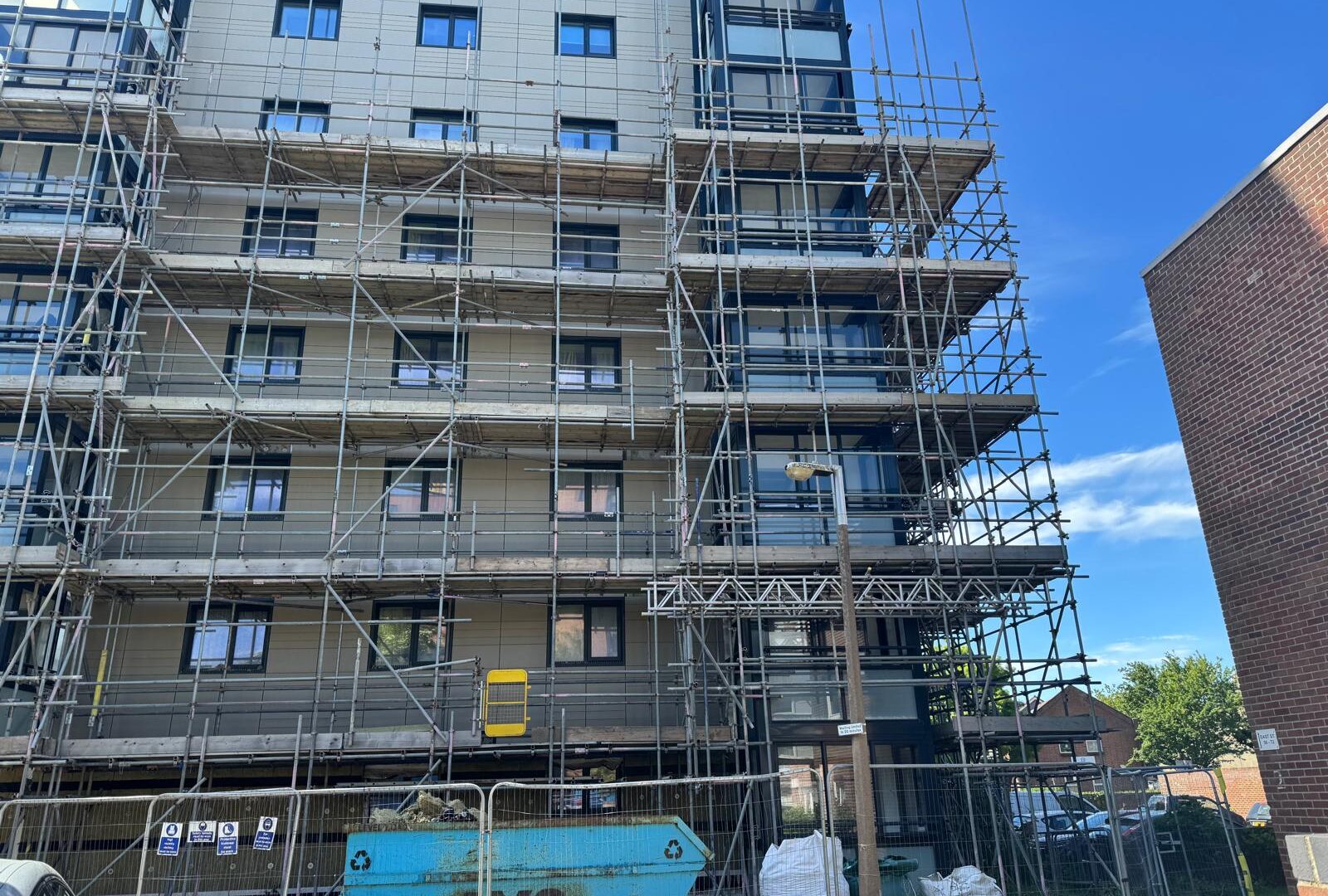 Scaffold platforms and a construction hoist beside a residential tower at Project Admiral in Poole