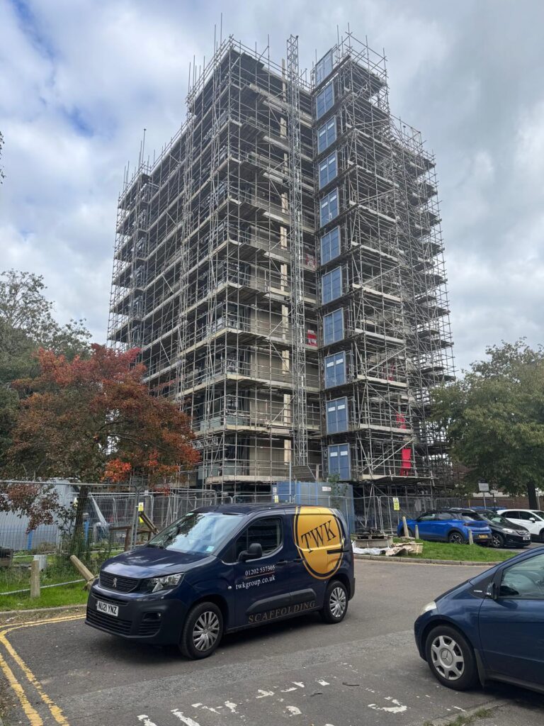 Elevation scaffold around a Project Admiral residential tower, with a TWK van in the foreground